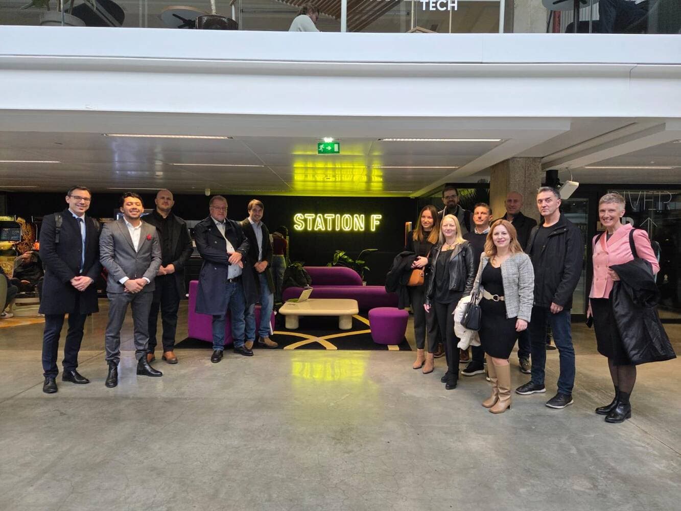 Croatian delegation in front of Station F neon sign